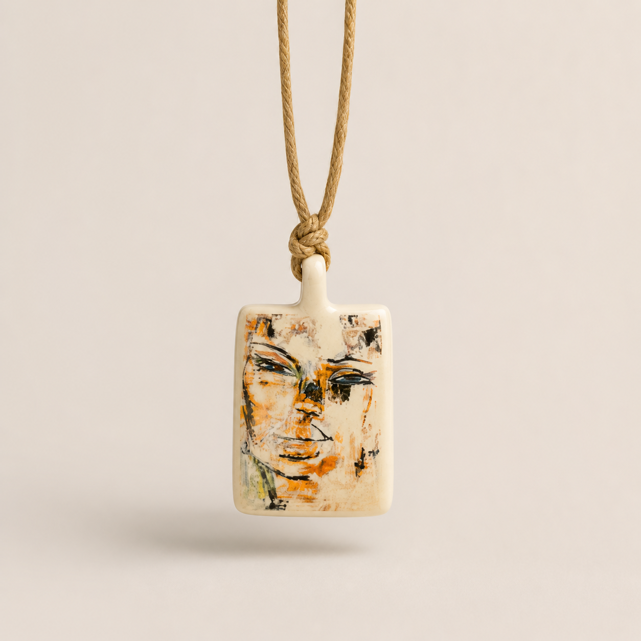 Limoges porcelain pendant with abstract face artwork by Niko on natural cord